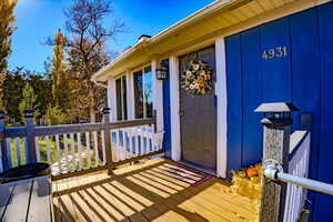 Doorway to property with a wooden deck
