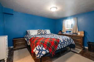 Bedroom with baseboards and a textured ceiling