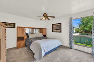 Main floor primary  bedroom with large window to backyard