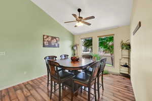 Dining area with vaulted ceiling and a ceiling fan