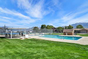 Community pool with a patio area and a mountain view