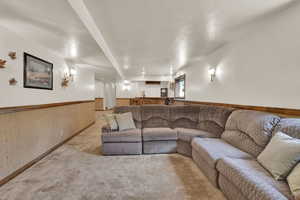 Living area featuring a brick fireplace and carpet
