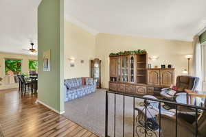 Living area with light wood-style flooring, high vaulted ceiling