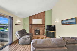 Living area with vaulted  ceiling, a fireplace.