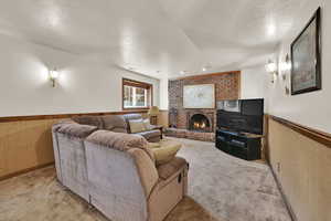Living area featuring a brick fireplace and carpet