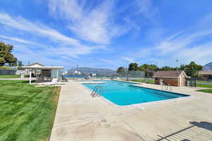 Community pool with a patio