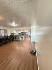 Dining area featuring light wood-type flooring and a textured ceiling