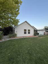 View of home's exterior with a yard