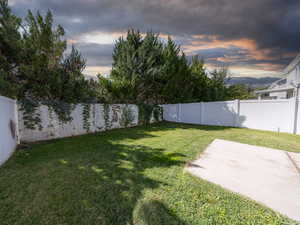 Fenced backyard featuring a patio