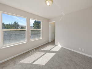 Empty room featuring baseboards and carpet