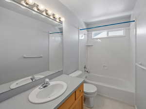 Full bath with shower / tub combination, vanity, and light tile patterned floors