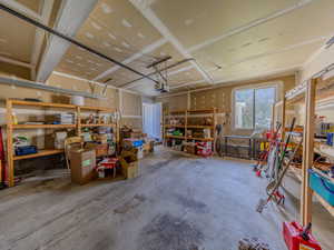 Garage featuring a workshop area and a garage door opener