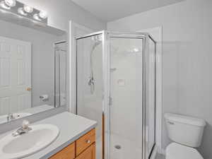 Bathroom featuring vanity and a stall shower