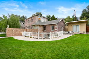 Rear view of property featuring a patio and brick siding