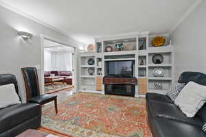 Living room featuring crown molding and light wood-style floors