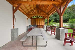 View of patio featuring a grill and outdoor dining space