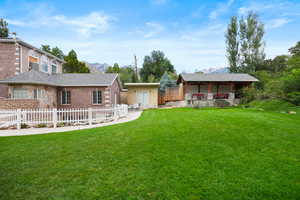View of yard with a deck with mountain view and an outbuilding