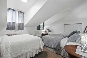 Carpeted bedroom with vaulted ceiling