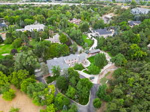 Aerial view of property's location with nearby suburban area and a tree filled landscape