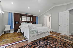 Bedroom featuring lofted ceiling, recessed lighting, and crown molding