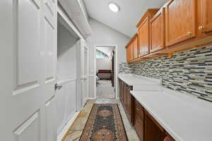 Laundry area with stone tile floors and washer / clothes dryer