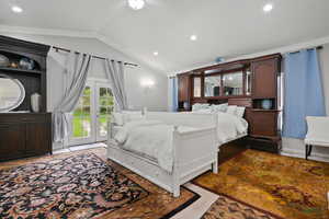 Bedroom featuring access to outside, lofted ceiling, recessed lighting, and french doors