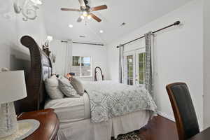 Bedroom with wood finished floors, access to exterior, french doors, lofted ceiling, and ceiling fan