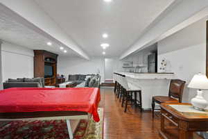 Playroom featuring pool table, a textured ceiling, dark wood-style flooring, and recessed lighting