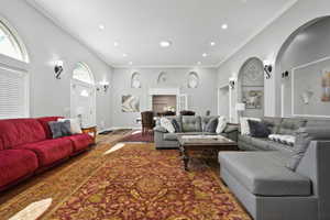 Living room featuring crown molding, recessed lighting, and wood finished floors