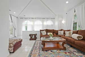 Living room featuring light tile patterned floors, recessed lighting, and healthy amount of natural light