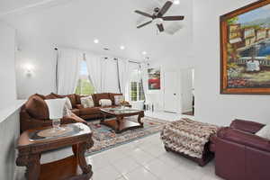 Living room with light tile patterned flooring, a ceiling fan, recessed lighting, and high vaulted ceiling