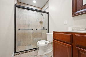 Full bathroom featuring a stall shower and vanity