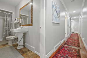 Hallway featuring baseboards and ornamental molding
