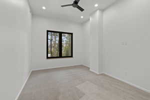 Empty room featuring light carpet, a ceiling fan, and recessed lighting