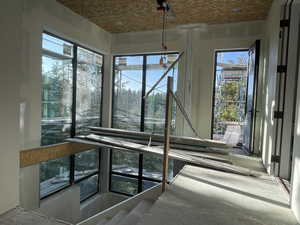 Construction update: Entry way to home with massive windows, view and in-wall elevator.