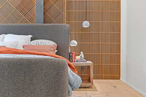 Bedroom with wood-type flooring and baseboards