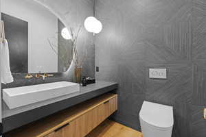 Bathroom with vanity and tile walls