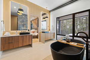Bathroom featuring vanity and a soaking tub