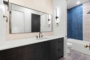 Bathroom with vanity and tub / shower combination