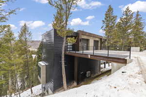 Snow covered property with a deck