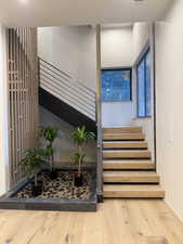 Staircase featuring wood-type flooring and baseboards