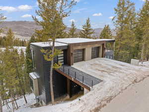View of front facade featuring a mountain view, driveway, and an attached garage