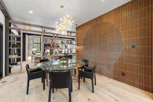 Dining area featuring wood-type flooring and a chandelier
