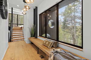 Hall featuring light wood-style flooring and baseboards