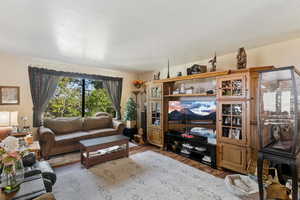 Living room with wood finished floors and a textured ceiling