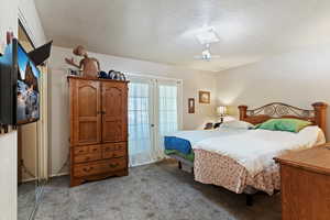 Carpeted bedroom with a textured ceiling