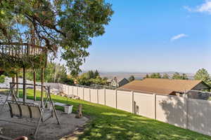 Fenced backyard featuring a residential view