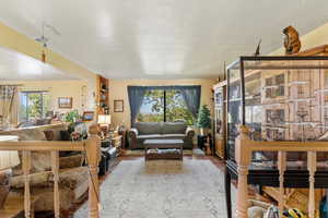 Living area featuring wood finished floors and a textured ceiling