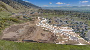 Aerial overview of property's location with mountains and nearby suburban area