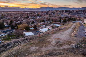 Aerial overview of property's location featuring a mountain backdrop and nearby suburban area